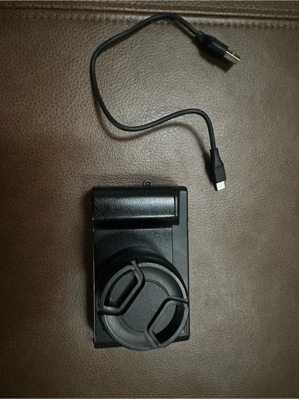 Compact Black Digital Camera with USB Cable and Lens Cap